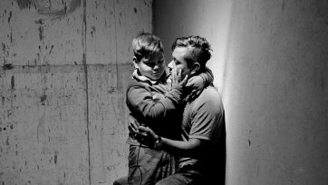 Carlos Soyos, 34, a migrant from Guatemala City, Guatemala and his son, Enderson Soyos, 8, take a self portrait at El Buen Samaritano migrants shelter, Juarez, Chihuahua, Mexico, 2021 Adam Ferguson