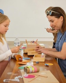 Parents and children at a table with craft activities Parents and children at a table with craft activities