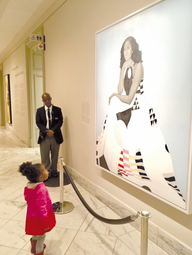Parker Curry viewing portrait of Michelle Obama